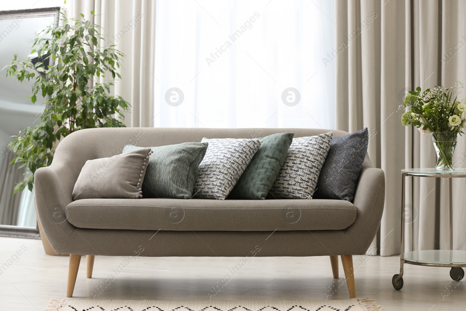 Photo of Sofa with pillows in modern living room interior