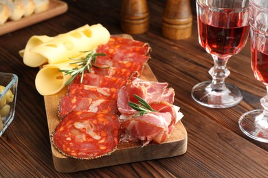Photo of Delicious charcuterie board served on wooden table