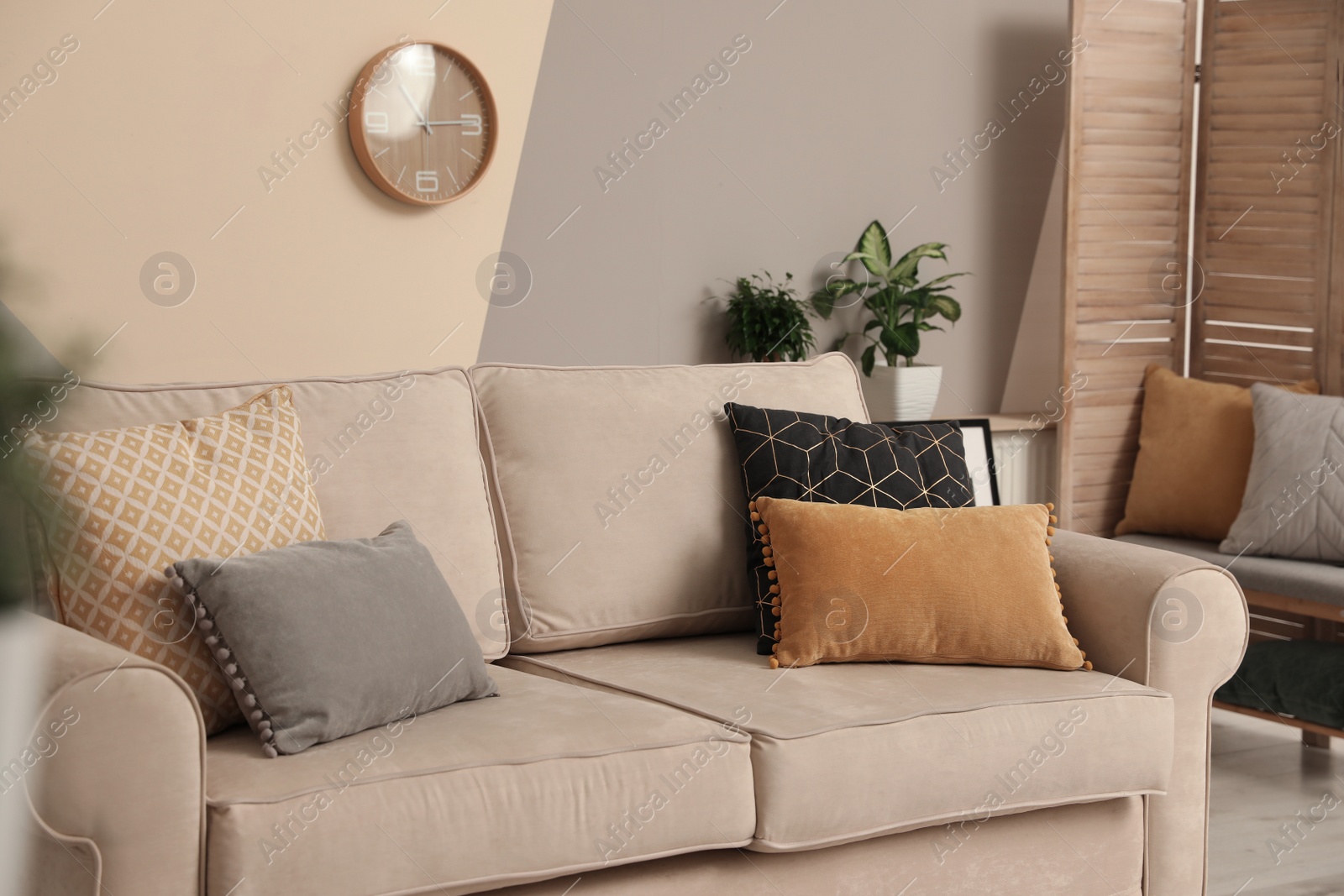 Photo of Modern comfortable sofa with pillows indoors. Stylish room interior