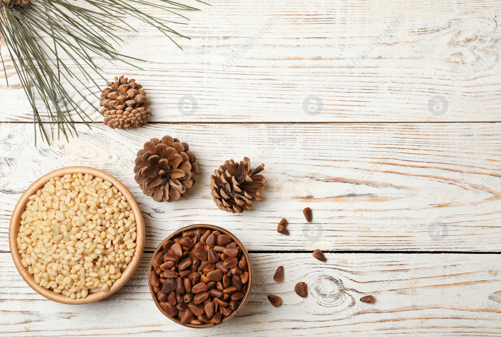 Photo of Flat lay composition with pine nuts and space for text on wooden background