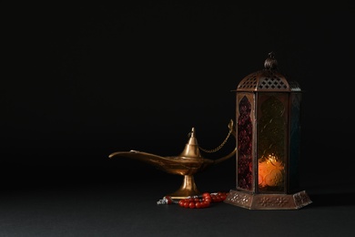 Photo of Composition with Muslim lamp on black background. Fanous as Ramadan symbol