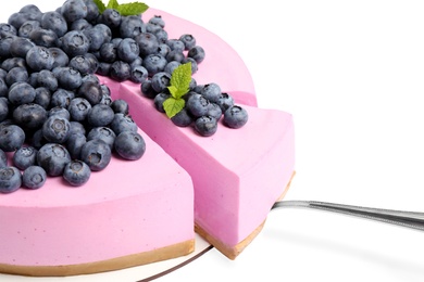 Photo of Cut tasty blueberry cake and shovel on white background, closeup