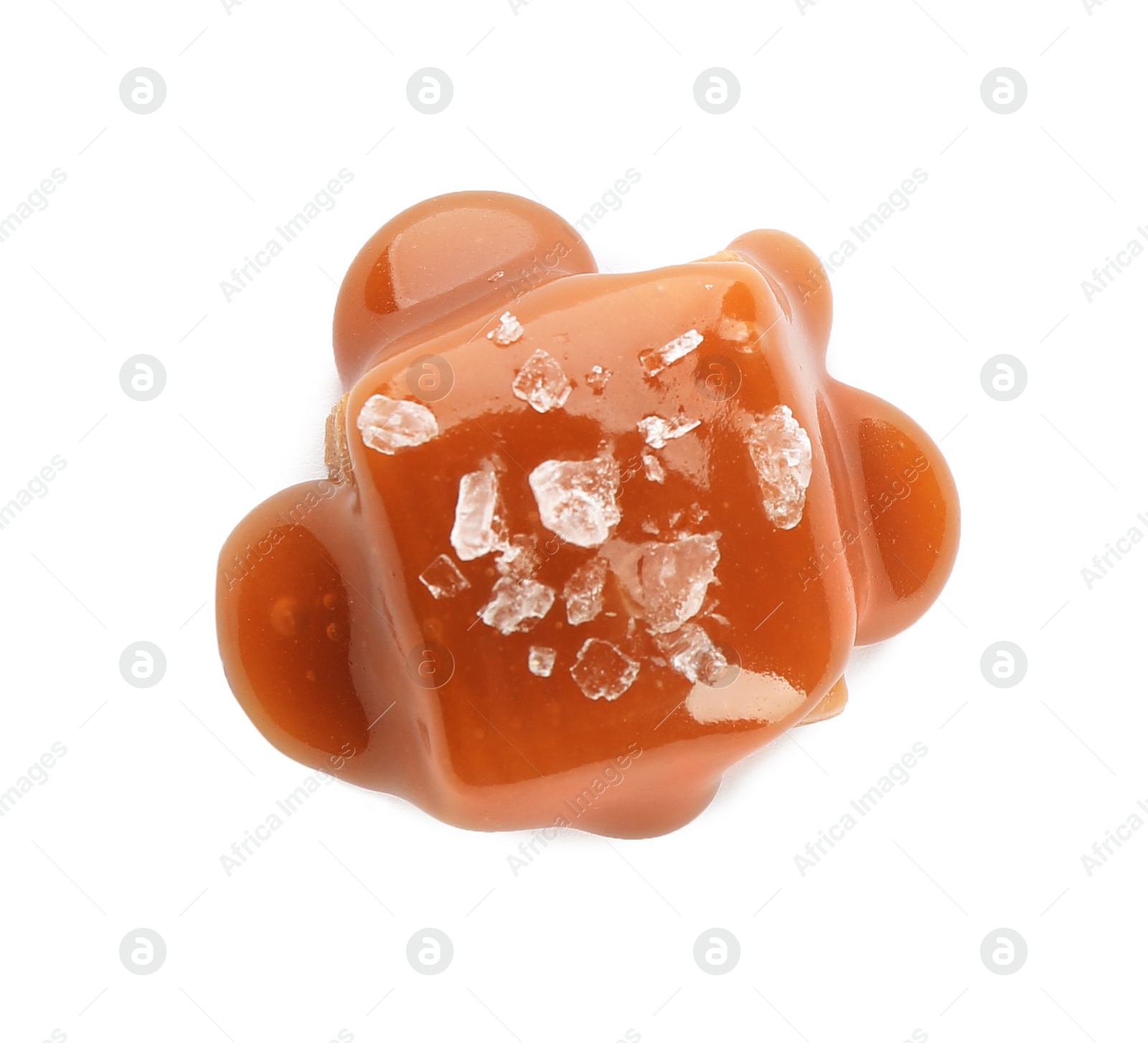 Photo of Delicious candy with caramel sauce and salt on white background, top view