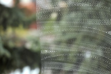 Photo of Cleaning foam on window glass, closeup view