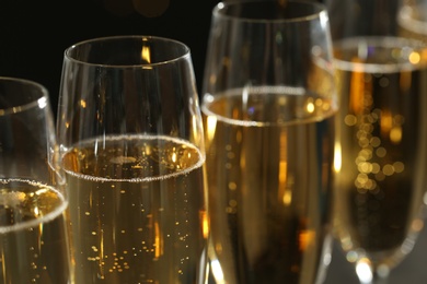 Photo of Glasses of champagne on dark background, closeup