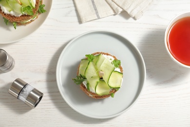 Photo of Flat lay composition with traditional English cucumber sandwiches on white wooden background