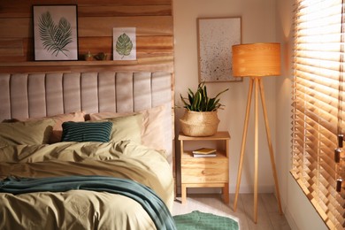 Photo of Comfortable bed with new pistachio linens in modern room interior