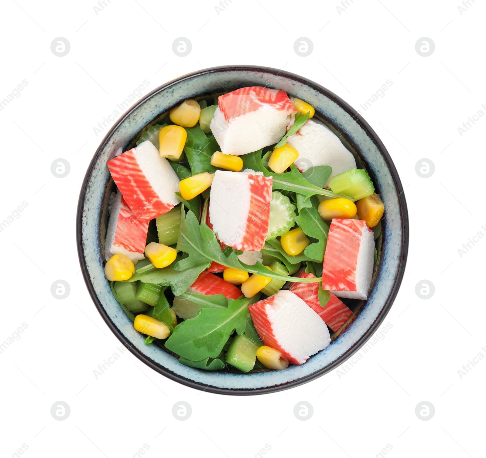 Photo of Tasty crab stick salad in bowl isolated on white, top view