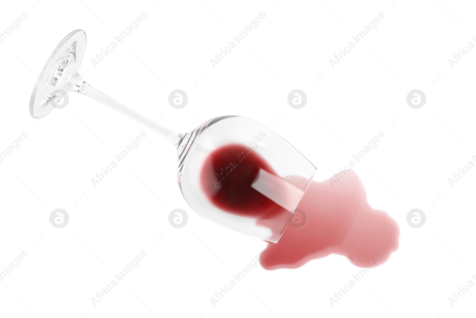 Photo of Transparent glass and spilled exquisite red wine on white background, top view