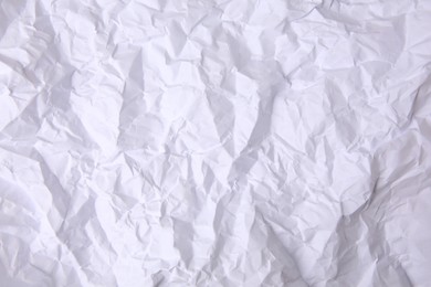 Sheet of crumpled paper white as background, top view