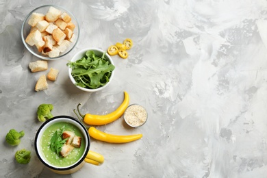 Photo of Flat lay composition with broccoli cream soup on grey table, space for text