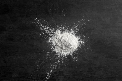 Heap of wheat flour on gray background, top view