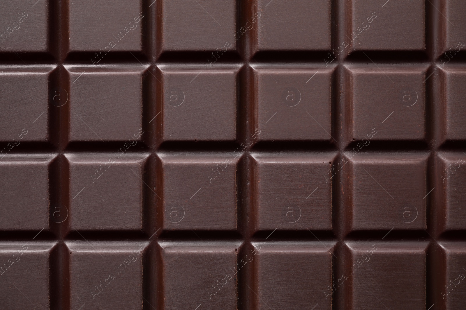 Photo of Delicious dark chocolate bar as background, top view