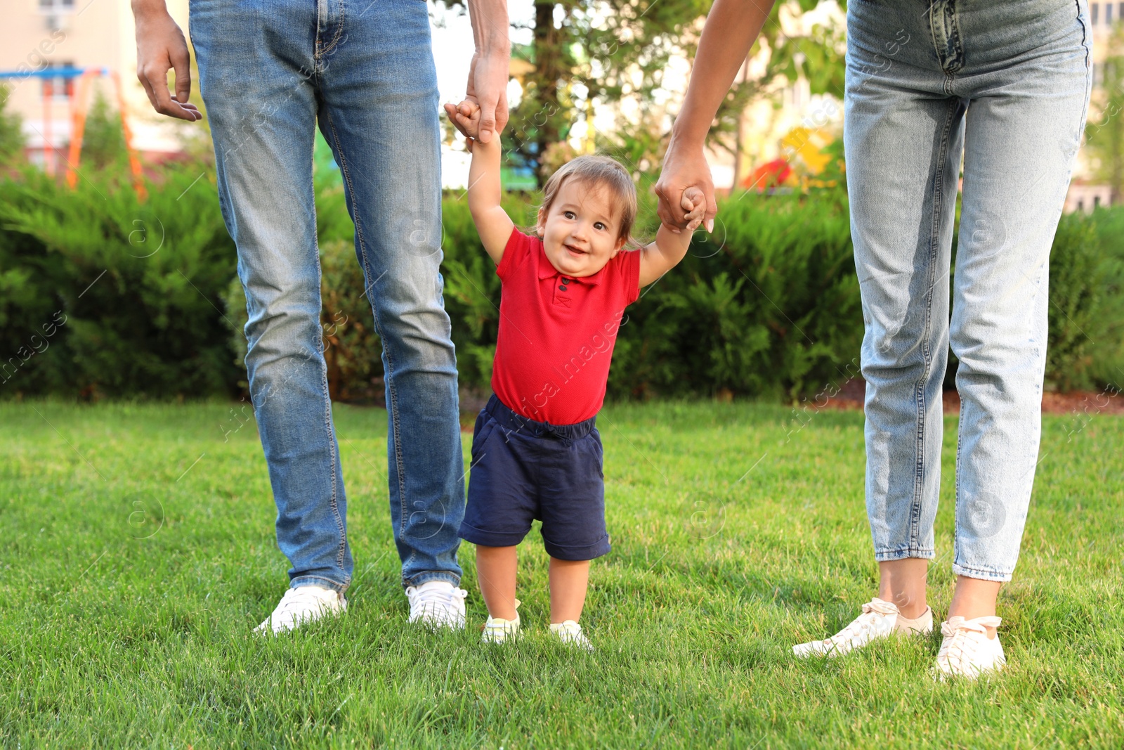 Photo of Happy family with adorable little baby outdoors