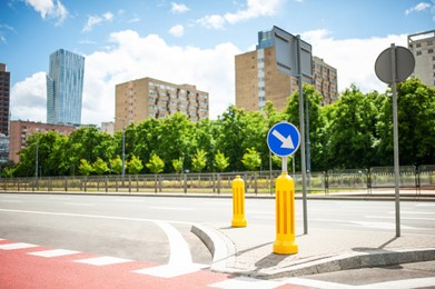 Traffic sign keep right near buildings on city street