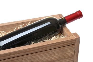 Photo of Open wooden crate with bottle of wine isolated on white, closeup
