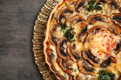 Photo of Delicious quiche with mushrooms on dark grey table, top view