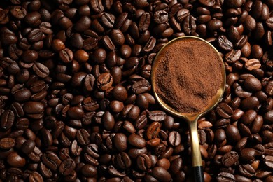 Photo of Spoon with ground coffee on roasted beans, top view. Space for text