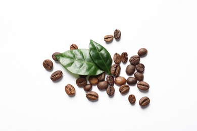 Photo of Fresh green coffee leaves and beans on white background, top view