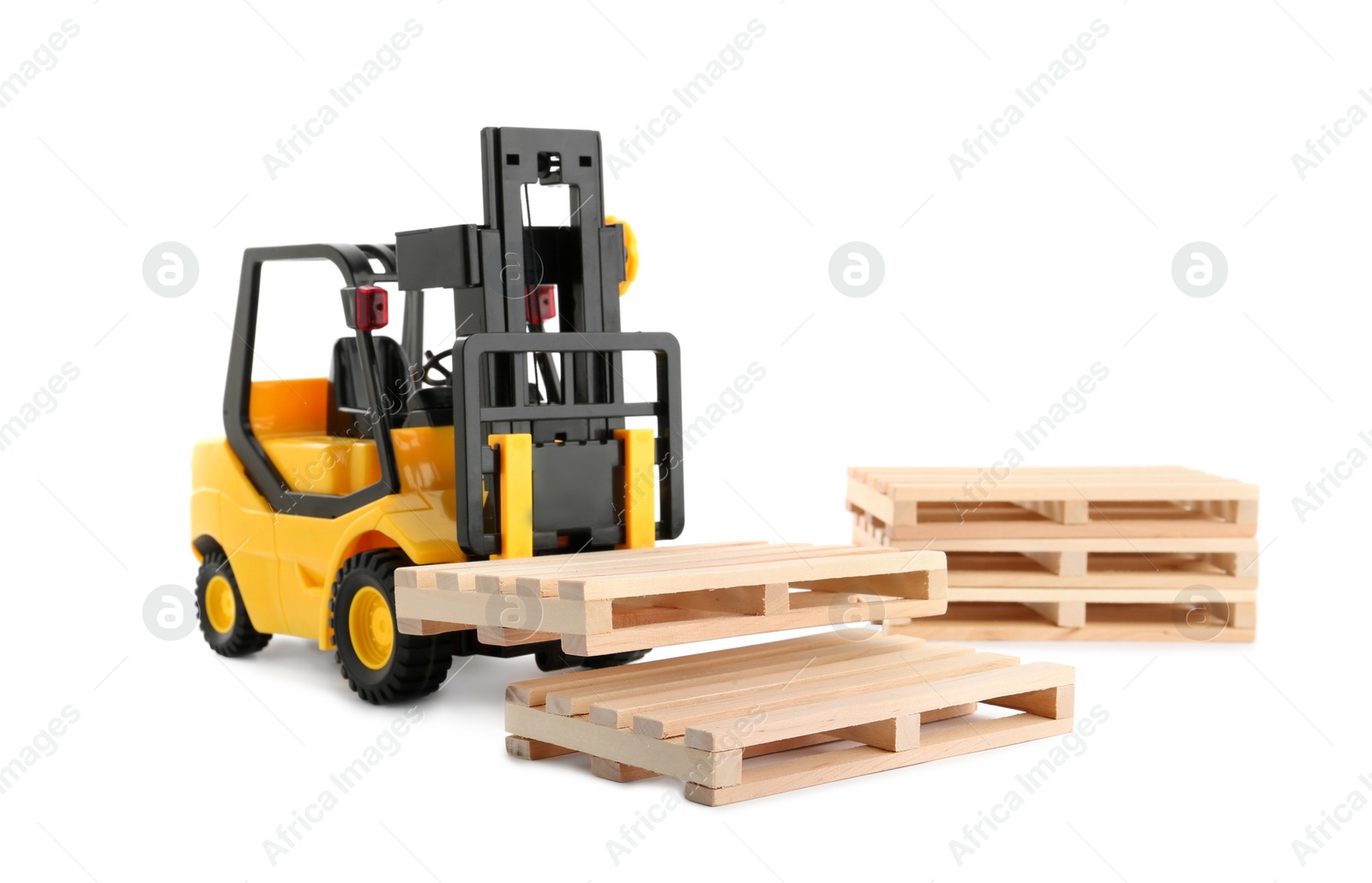 Photo of Toy forklift truck with wooden pallets on white background