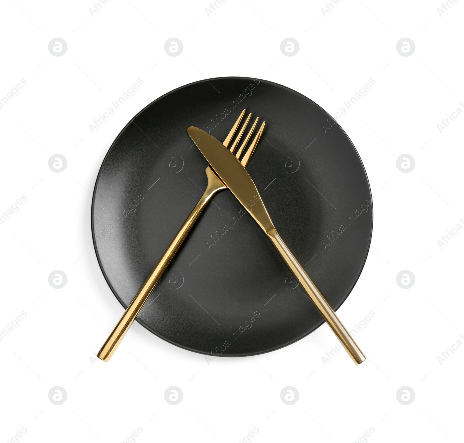 Photo of Clean plate with golden cutlery on white background, top view