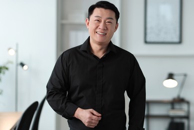 Photo of Portrait of smiling friendly businessman in office