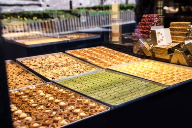 Shop with different turkish sweets, view through window glass