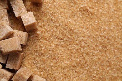 Photo of Different types of brown sugar as background, top view. Space for text