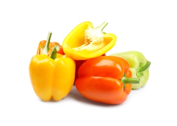 Whole and cut bell peppers on white background