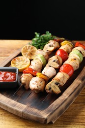 Delicious shish kebabs with grilled vegetables served on wooden table