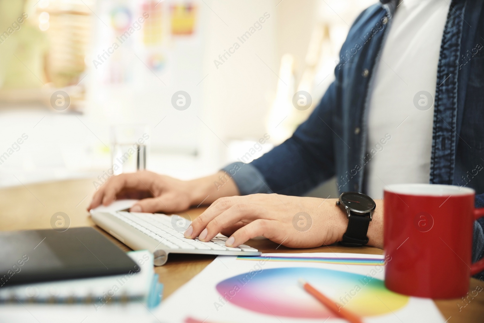 Photo of Professional designer working with computer in office, closeup