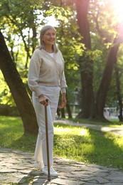 Photo of Senior woman with walking cane in park