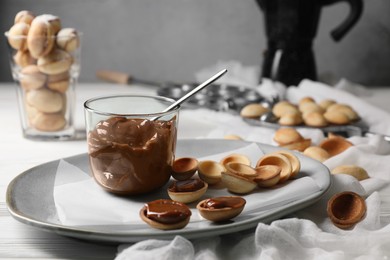 Photo of Delicious walnut shaped cookies with condensed milk on table