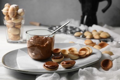 Delicious walnut shaped cookies with condensed milk on table