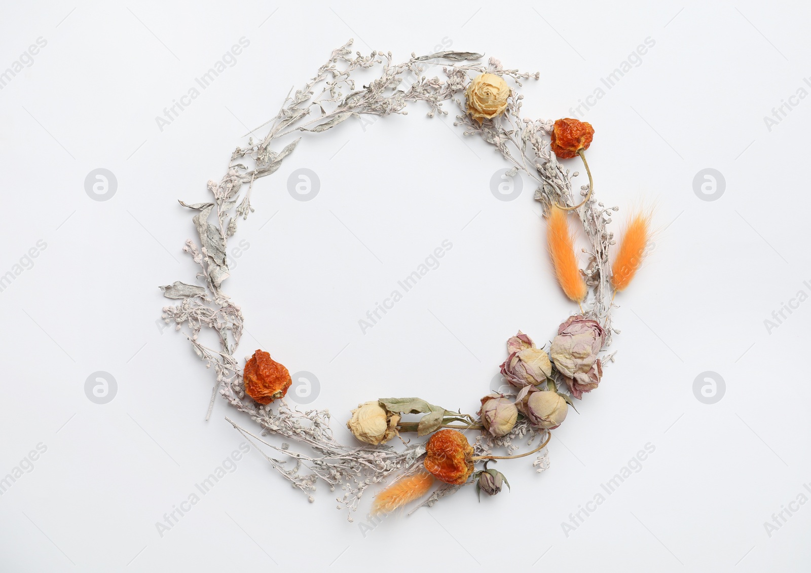 Photo of Dried flowers, leaves and spikes arranged in shape of wreath on white background, flat lay with space for text. Autumnal aesthetic