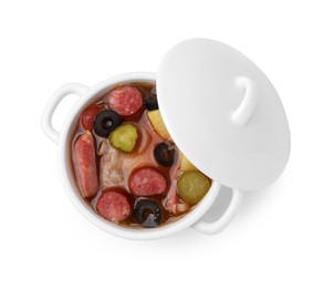 Photo of Meat solyanka soup with thin dry smoked sausages in pot isolated on white, top view