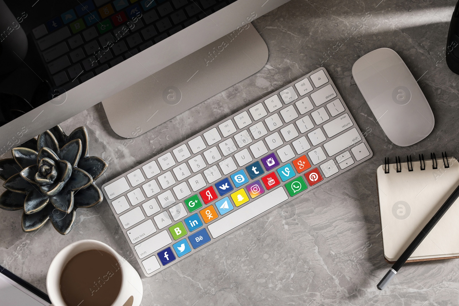 Image of MYKOLAIV, UKRAINE - APRIL 30, 2020: Computer keyboard with social media apps logotypes on marble table, flat lay