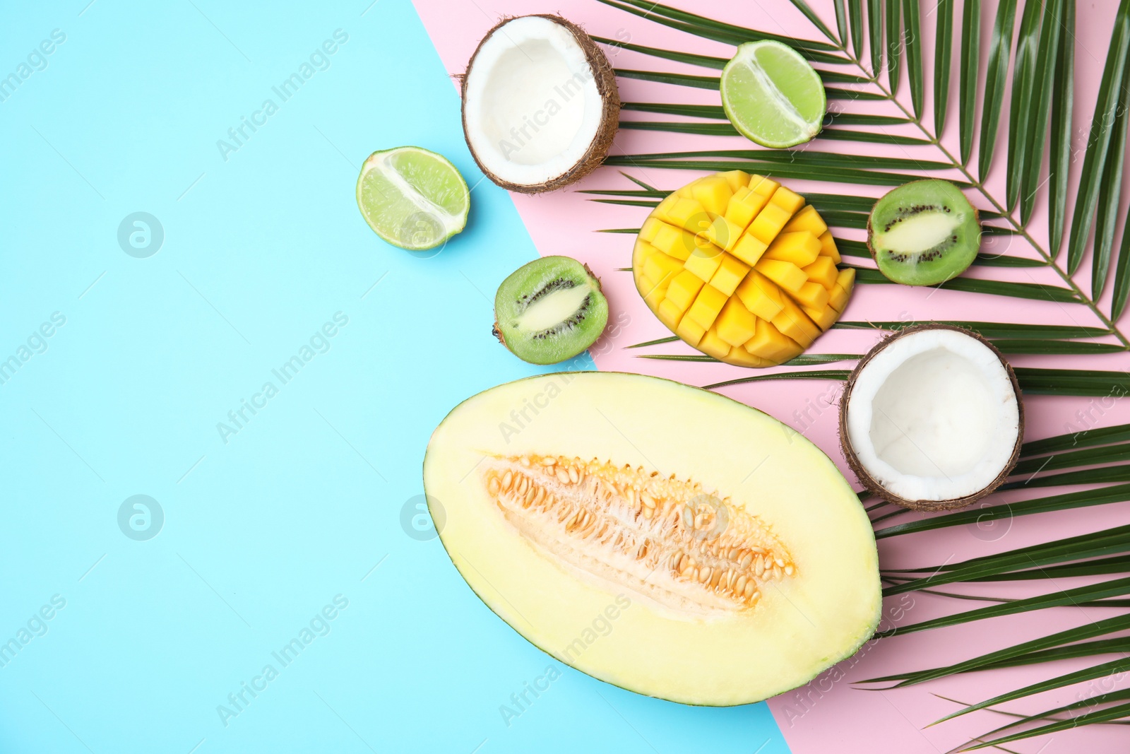 Photo of Flat lay composition with melon, other fruits and space for text on color background