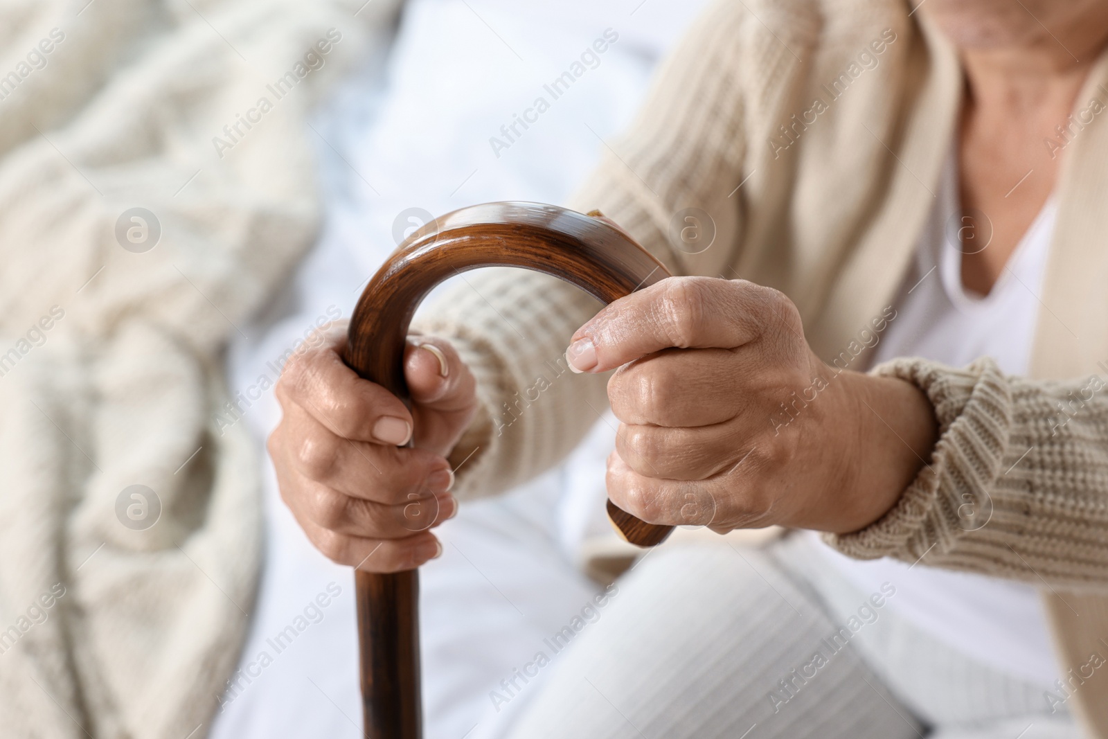 Photo of Elderly woman with walking cane indoors, closeup. Home care service