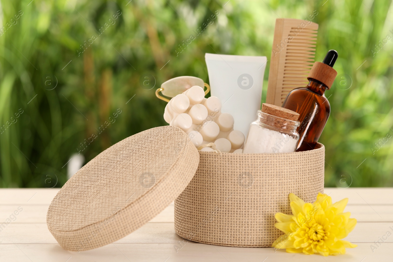 Photo of Spa gift set with different products on white wooden table against blurred background