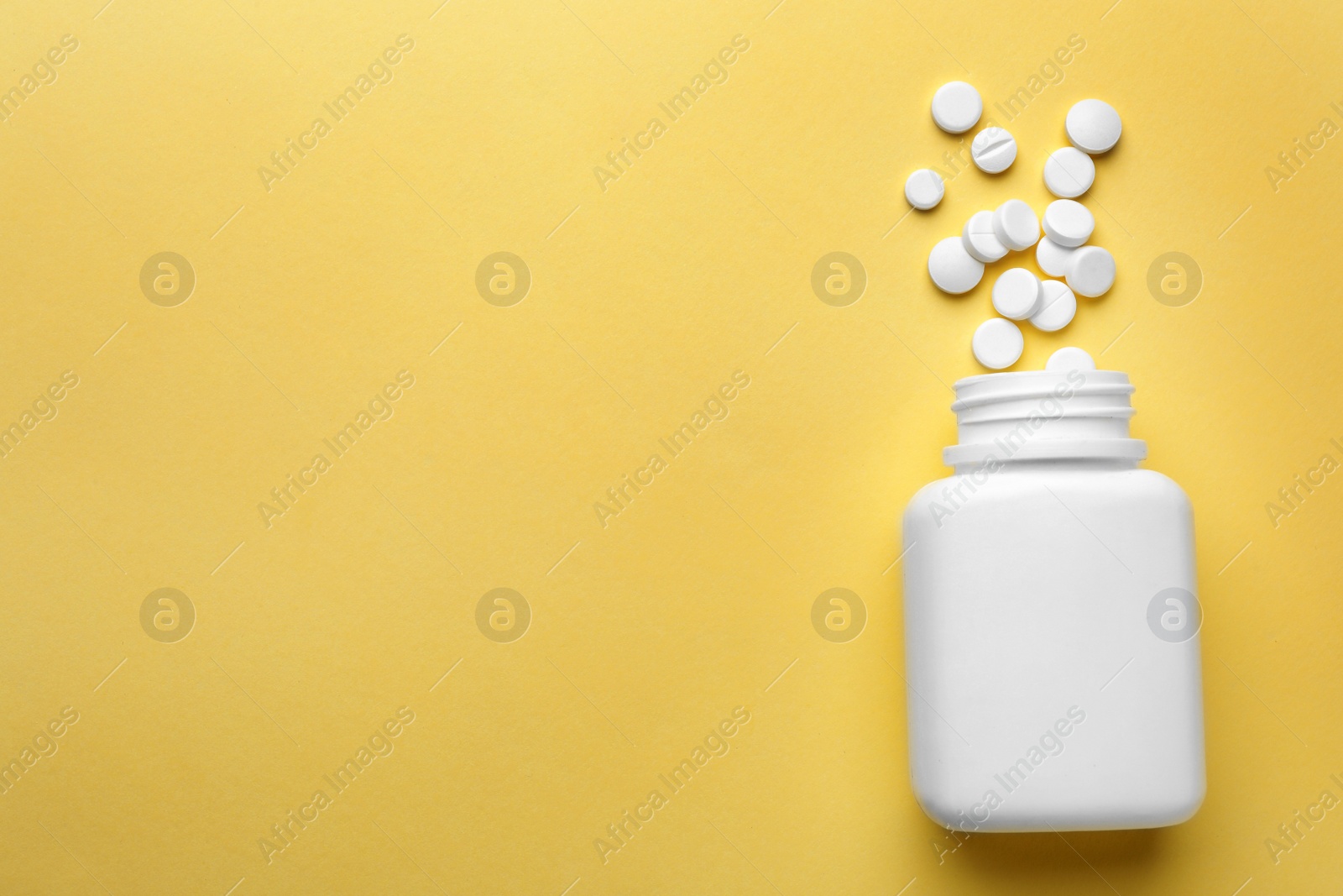 Photo of Bottle with different pills on color background, flat lay. Space for text