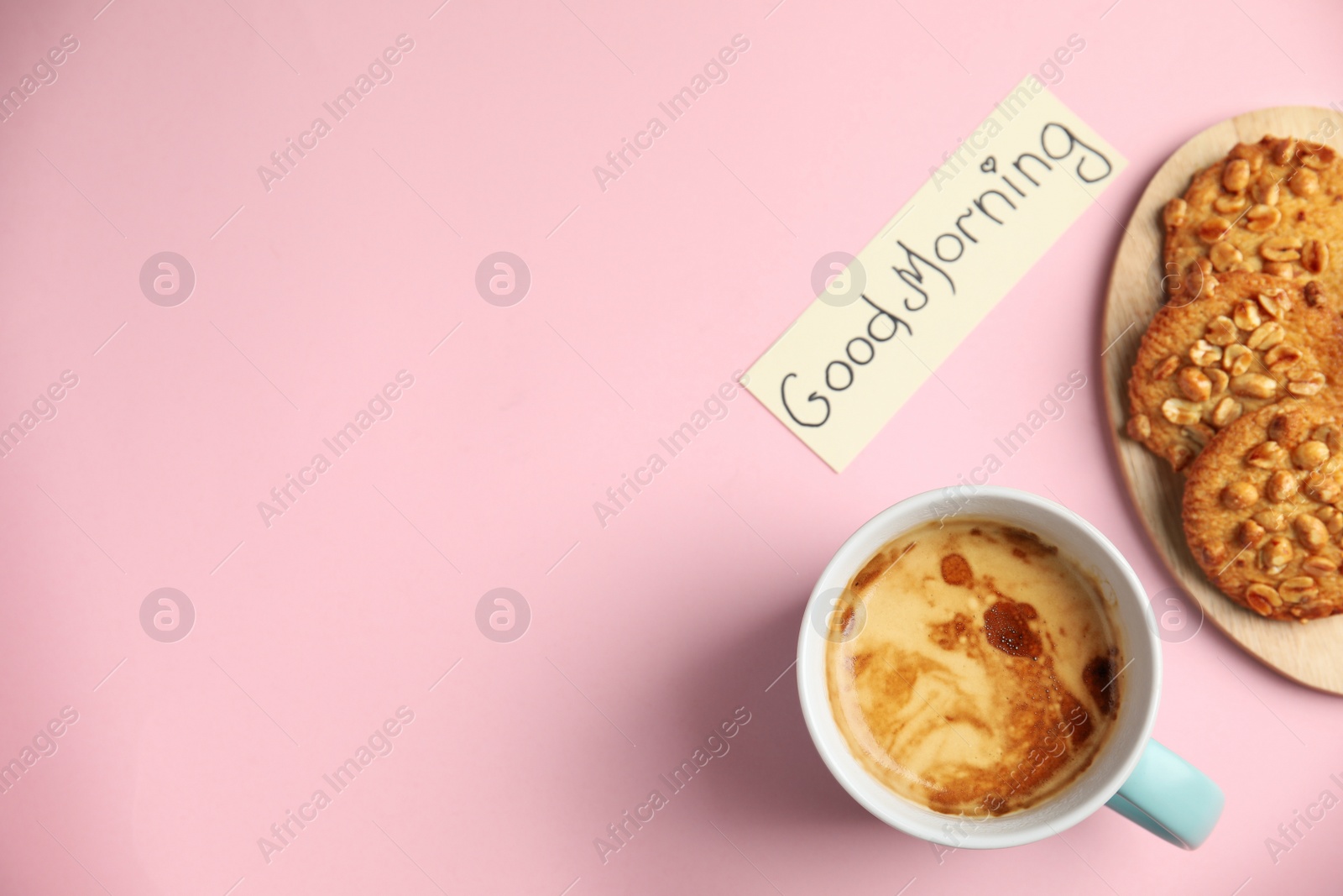 Photo of Delicious coffee, cookies and card with words GOOD MORNING on pink background, flat lay. Space for text