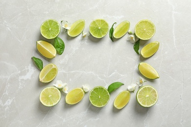 Frame made of fresh ripe limes on light background, top view