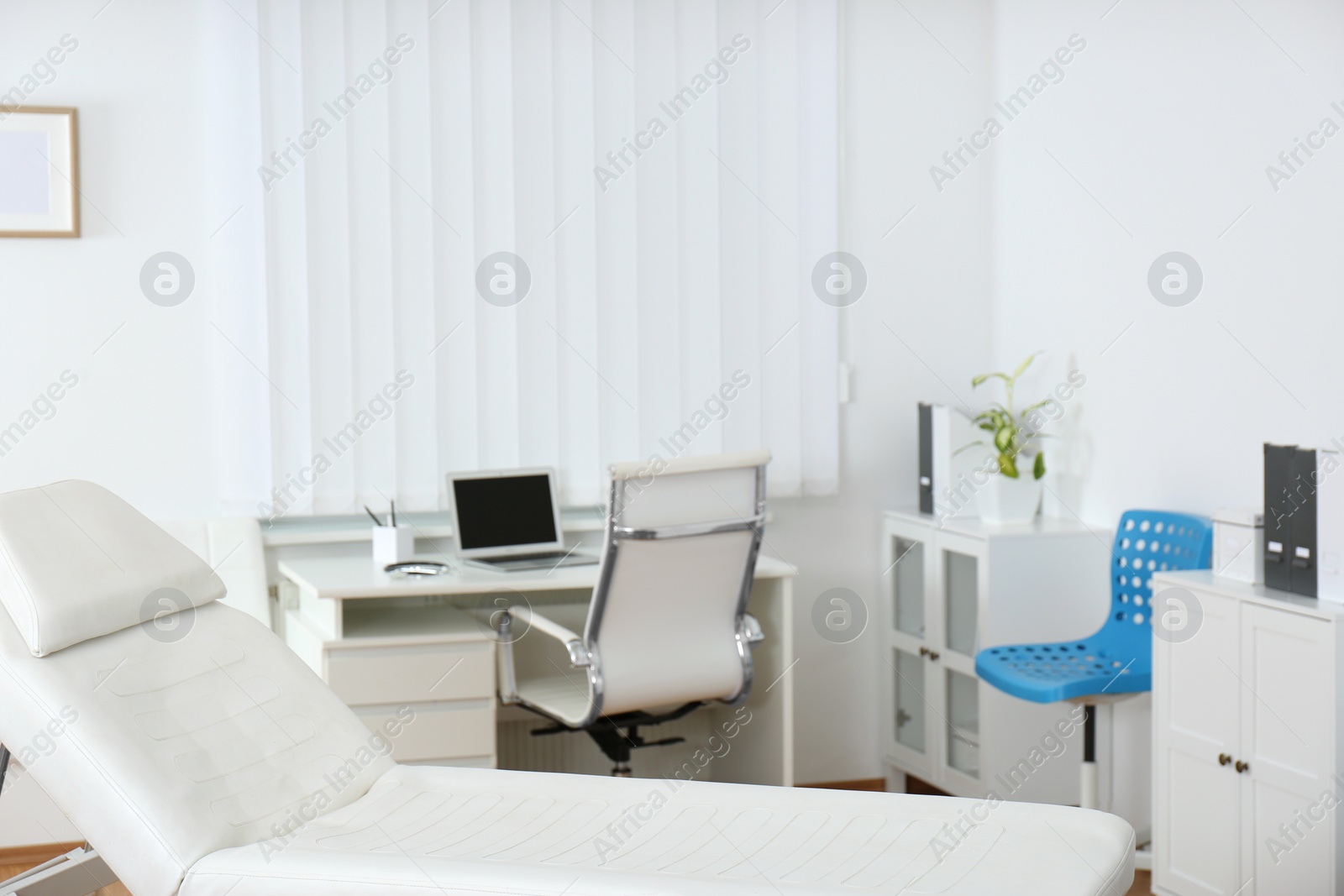 Photo of Modern medical examination couch in doctor's office