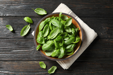 Fresh green basil on black wooden table, flat lay