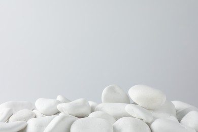 Photo of Presentation for product. White pebbles on light background. Space for text