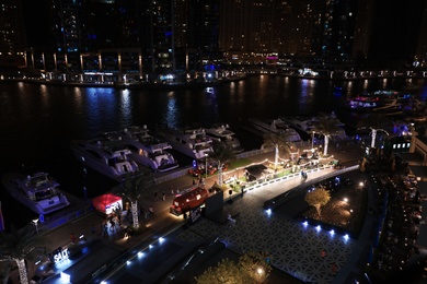 DUBAI, UNITED ARAB EMIRATES - NOVEMBER 03, 2018: Night cityscape of marina district with moored yachts