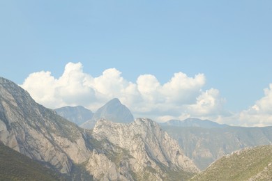 Photo of Majestic mountain landscape under blue sky with clouds