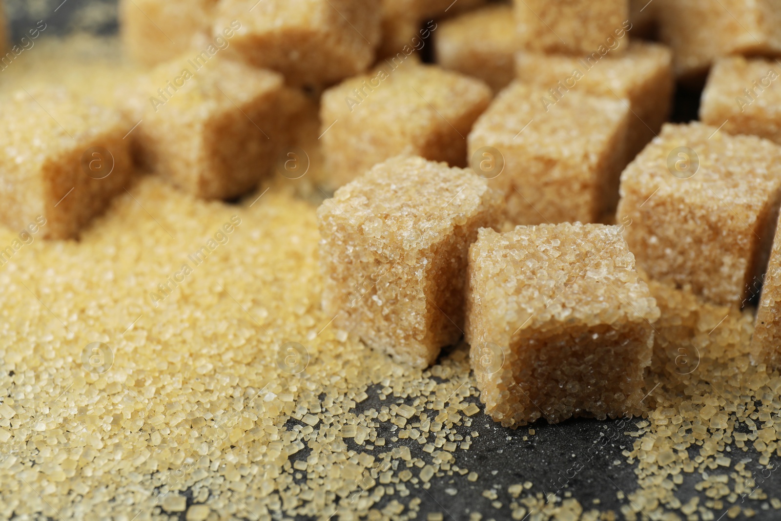 Photo of Brown sugar cubes on table, closeup view