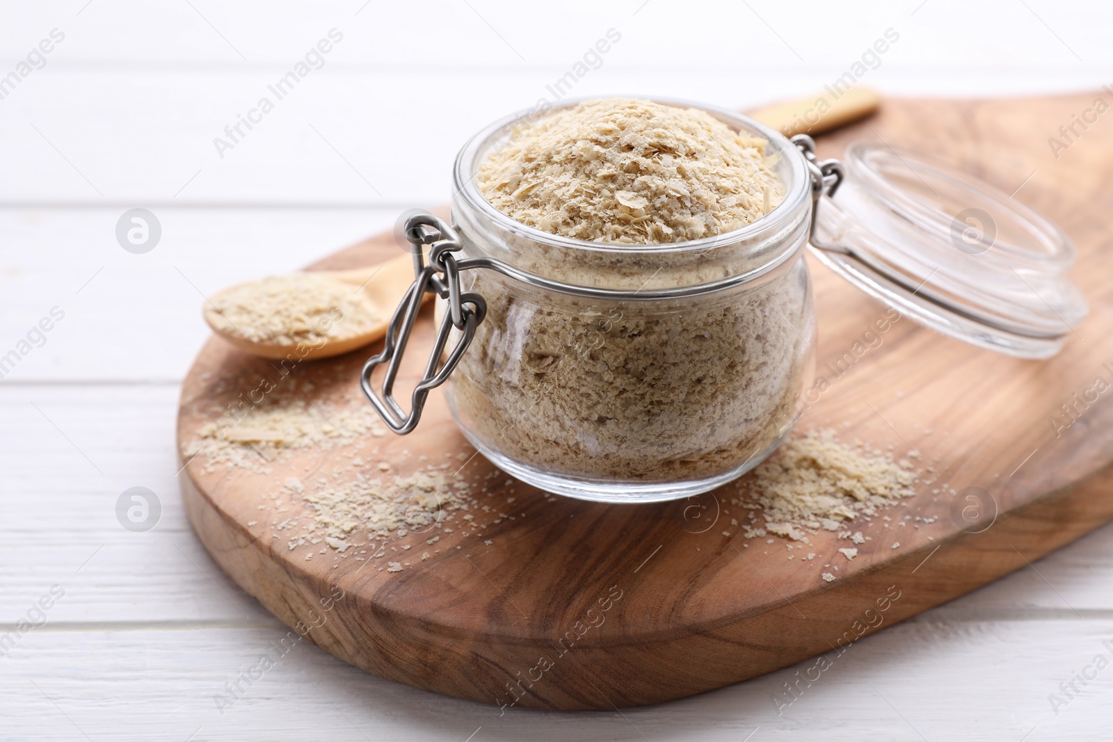 Photo of Beer yeast flakes on white wooden table, closeup